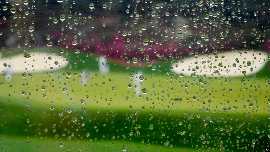 Rain falls on a plexiglass divider in the grandstand at Augusta National golf course on April 6, 2022, in Augusta, Ga. (AP Photo/Charlie Riedel)