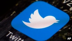 FILE - The Twitter icon is displayed on a mobile phone in Philadelphia on April 26, 2017. 