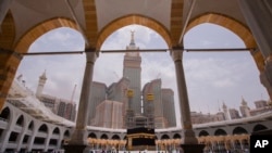 FILE - Muslim pilgrims keep social distancing as they circumambulate the Kaaba, the cubic building at the Grand Mosque, during the final ritual of the hajj that pilgrims must perform before they return home, in the Muslim holy city of Mecca, Saudi Arabia,