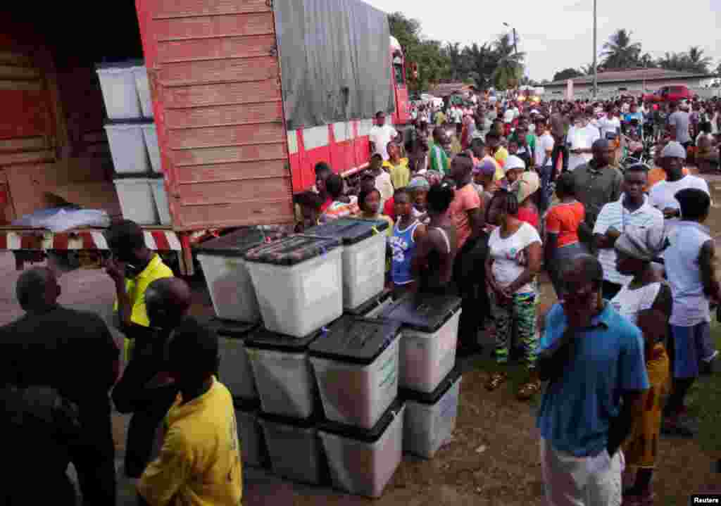 People wait to vote during the presidential election at a polling station in Monrovia, Liberia, Oct. 10, 2017.