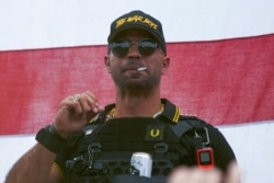 FILE - Proud Boys leader Henry "Enrique" Tarrio wears a hat that says The War Boys during a rally in Portland, Ore., Sept. 26, 2020.