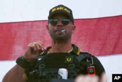 FILE - Proud Boys leader Henry "Enrique" Tarrio wears a hat that says The War Boys during a rally in Portland, Ore., Sept. 26, 2020.