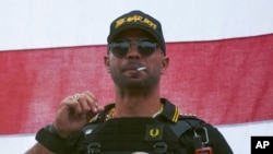 FILE - Proud Boys leader Henry "Enrique" Tarrio wears a hat that says The War Boys during a rally in Portland, Oregon, Sept. 26, 2020.