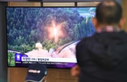People watch television file footage of a North Korean missile launch at a railway station in Seoul, Oct. 31, 2019. North Korea fired two projectiles Oct. 31, the South's military said.