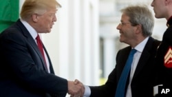 President Donald Trump greets Italian Prime Minister Paolo Gentiloni as he arrives at the West Wing of the White House in Washington, April 20, 2017.