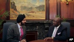 FILE - Then-South Africa Deputy Minister of Finance Nhlanhla Nene (right) met with Ajay Banga, MasterCard Worldwide President and CEO (left) in Pretoria on Thursday, Jan. 17, 2013.