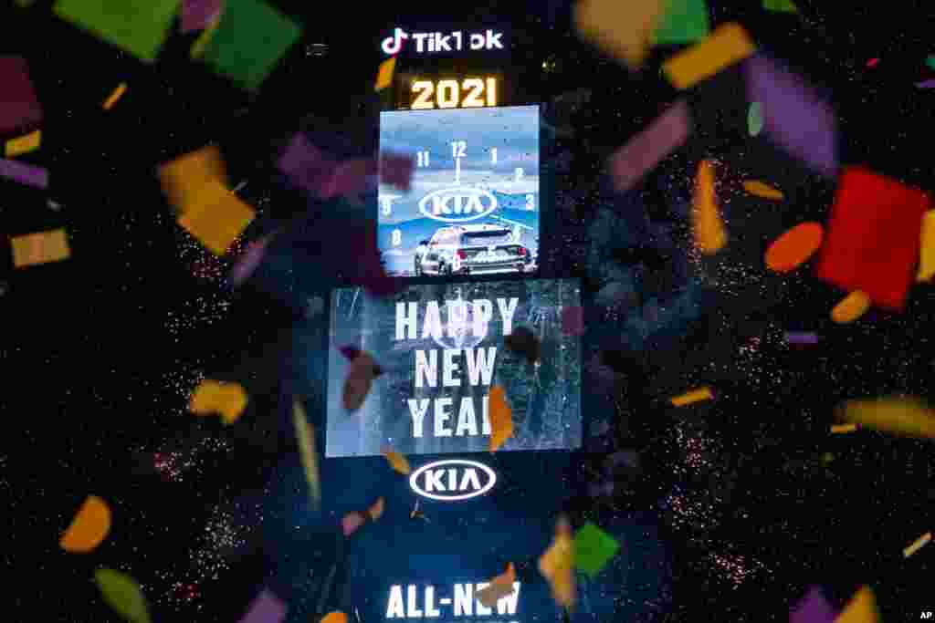 Confetti flies after the Times Square New Year's Eve Ball drops in a nearly empty Times Square, Jan. 1, 2021, in New York, as the area normally packed with revelers remained closed off to due to the coronavirus pandemic.