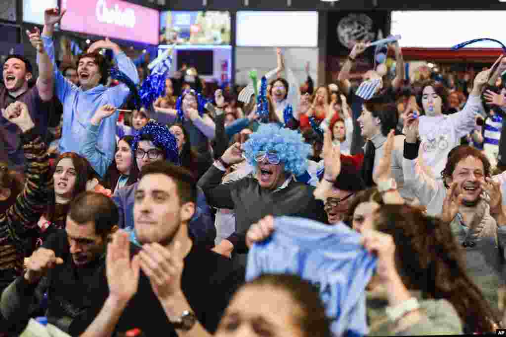 Fans of Uruguay&#39;s soccer team celebrate their team&#39;s 3-0 victory over Russia, after watching the Russia 2018 World Cup match via live broadcast in downtown Montevideo, Uruguay.