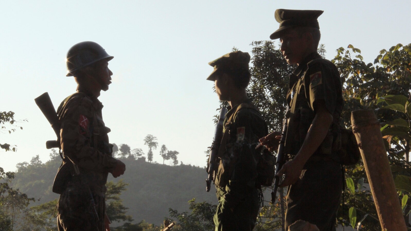 FILE - Three soldiers patrol along a mountain near Laiza, Kachin State, Myanmar, Nov. 30, 2016.