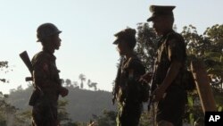 FILE - Three soldiers patrol along a mountain near Laiza, Kachin State, Myanmar, Nov. 30, 2016.