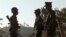 FILE - Three soldiers patrol along a mountain near Laiza, Kachin State, Myanmar, Nov. 30, 2016.