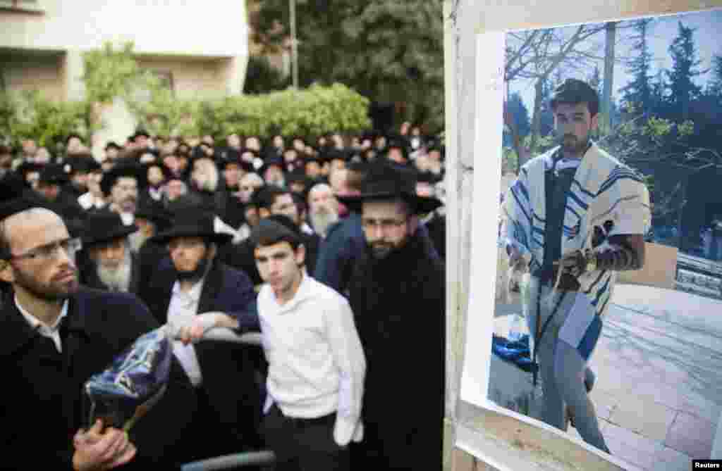 A photograph of Yoav Hattab, killed in an attack on a Paris grocery on Friday, is displayed during a procession before his funeral in Bnei Brak near Tel Aviv, Jan. 13, 2015. 