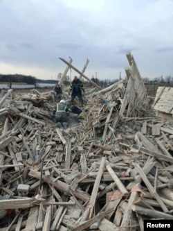 Rescuers remove a woman from debris after a military strike, as Russia's attack on Ukraine continues, in the town of Rubizhne, in Luhansk region, Ukraine April 6, 2022.
