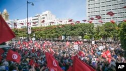 FILE: Demonstrators gather during a protest against Tunisian President Kais Saied, in Tunis, Tunisia, April 10, 2022.