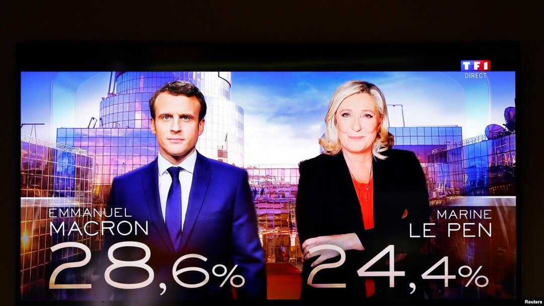 Una pantalla de televisión muestra los resultados electorales con los dos candidatos para la segunda vuelta en las elecciones presidenciales francesas de 2022, el presidente francés Emmanuel Macron y Marine Le Pen, líder de la Agrupación Nacional de extrema derecha francesa.