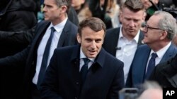 Current French President Emmanuel Macron and centrist candidate for reelection talks to supporters as he visits Spezet, Brittany, Tuesday, April 5, 2022.