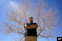 Benito Luna-Herrera, a 7th-grade social studies teacher at California City Middle School, poses for a photo, March 11, 2022. (AP Photo/Damian Dovarganes)