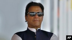 FILE: Pakistan's Prime Minister Imran Khan attends a military parade to mark Pakistan National Day, in Islamabad, Pakistan, March 23, 2022. 