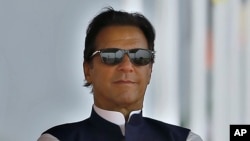 FILE - Pakistan's Prime Minister Imran Khan attends a military parade to mark Pakistan National Day, in Islamabad, Pakistan, March 23, 2022.