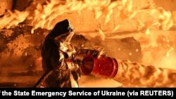 A firefighter works at the site of burning fuel storage facilities damaged by an airstrike, as Russia's attack on Ukraine continues, in Dnipropetrovsk region, Ukraine, in this handout image released April 6, 2022.