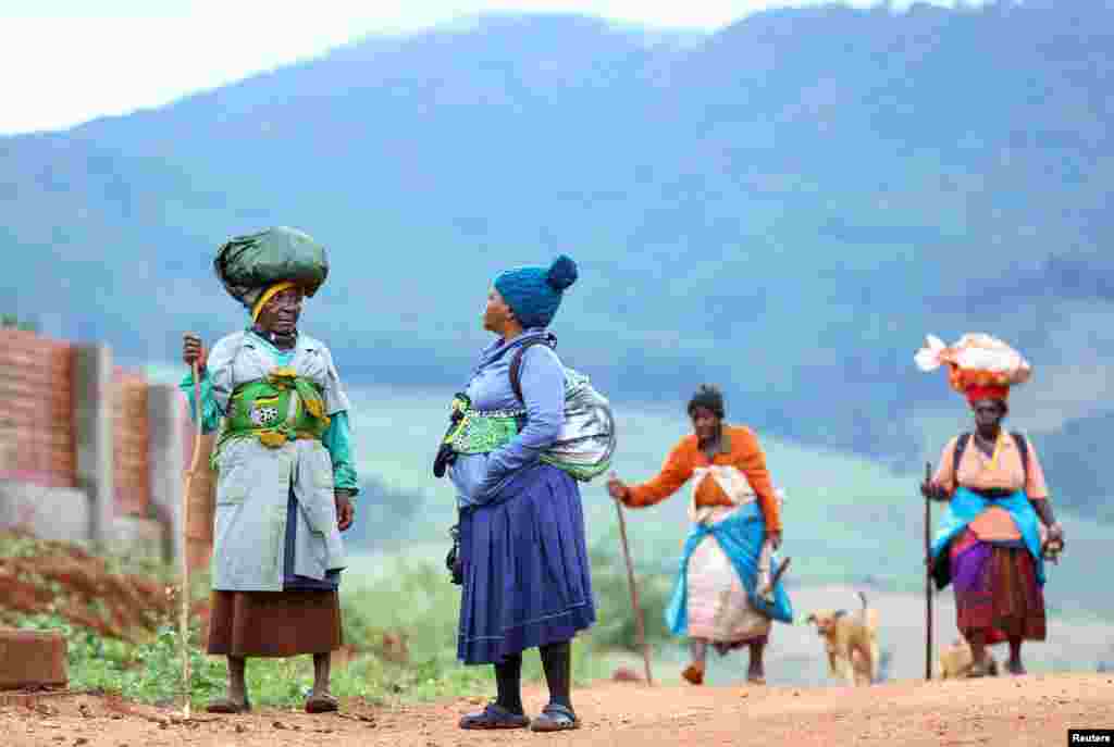 Women chat on their return from farming communal land at Tshakhuma village outside Thohoyandou, in Limpopo province, South Africa, April 9, 2022.