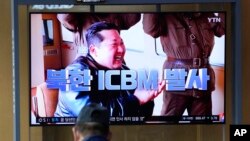 FILE - A man watches a TV screen showing a news program reporting about North Korea's ICBM with an image of North Korean leader Kim Jong Un at a train station in Seoul, South Korea, March 25, 2022