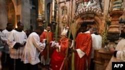 The head of the Roman Catholic Church in the Holy Land, Apostolic Administrator of the Latin Patriarchate Pierbattista Pizaballa leads the Palm Sunday procession at the Church of the Holy Sepulchre in Jerusalem's Old City, Apr. 10, 2022.