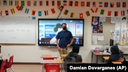 Benito Luna-Herrera, a 7th-grade social studies teacher, presents a mental health video, March 11, 2022. (AP Photo/Damian Dovarganes)