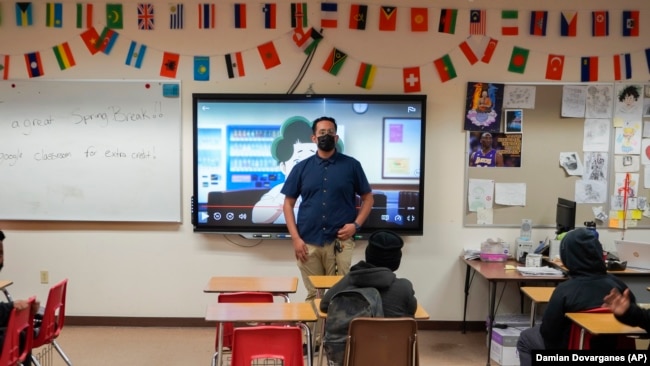 Benito Luna-Herrera, a 7th-grade social studies teacher, presents a mental health video, March 11, 2022. (AP Photo/Damian Dovarganes)