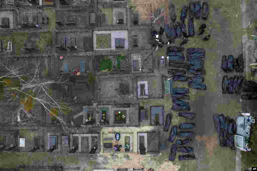 Policemen work to identify civilians who were killed during the Russian occupation in Bucha, Ukraine, on the outskirts of Kyiv.