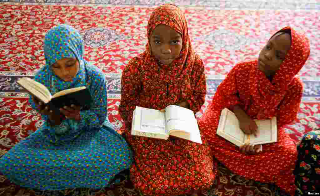 Muslim girls read the Koran before the start of the Friday prayers during the holy fasting month of Ramadan, inside Jamia mosque in Nairobi, Kenya.