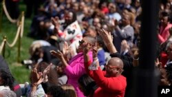 People applaud as Vice President Kamala Harris, accompanied by President Joe Biden and Judge Ketanji Brown Jackson, speaks during an event on the South Lawn of the White House in Washington, April 8, 2022.