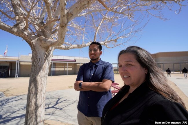 Mojave Unified School District Superintendent Katherine Aguirre, right, and Benito Luna-Herrera meet with his students, March 11, 2022. (AP Photo/Damian Dovarganes)