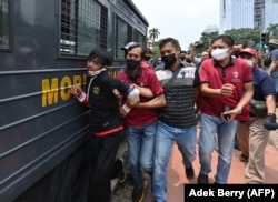 Polisi menangkap seorang pria saat unjuk rasa di Jakarta pada 11 April 2022. (Foto: AFP/Adek Berry)