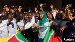 On Oct. 13, 2016, Kenya's Lands Minister Jacob Kaimenyi, 5th from left, and Mariamu El Maawy, 7th from left, principal secretary in the Lands and Physical Planning Ministry, stand with women who planned to climb Mount Kilimanjaro as part of a campaign for land rights in Nairobi, Kenya.