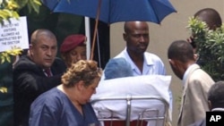 Former South African President Nelson Mandela is wheeled out on a stretcher, as he leaves the Milpark Hospital in Johannesburg, January 28, 2011