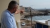 A Lebanese man points to the beach in Batroun, northern Lebanon, Nov. 2, 2024.