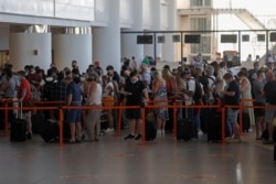 FILE - People wait in queues at Faro airport amid the coronavirus disease (COVID-19) pandemic, in Faro, Portugal, June 6, 2021.