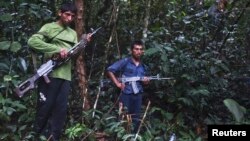 FILE - Members of Peru's Shining Path terrorist group are seen in a remote jungle region in southern Peru, Cuzco. Peruvian special forces rescued 26 children and 13 women, some of whom had been held captive for three decades, when they raided a southeastern jungle camp of the left-wing rebel group.