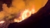 This image from video provided by the U.S. Geological Survey shows a lava lake erupting on the west caldera wall of the Kilauea volcano in Hawaii, on Dec. 23, 2024.