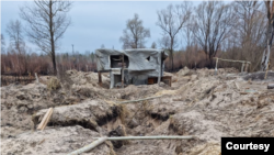 Trenches that Ukraine says Russian troops dug in radioactive soil near the Chernobyl nuclear power plant, damaged in a 1986 disaster, during a five-week occupation in February and March 2022. Photo taken on April 5, 2022. (Courtesy Evgen Kramarenko)