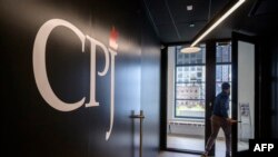 FILE: A staff member walks past a logo at the offices of the Committee to Protect Journalists (CPJ), in New York city on 10.5.2021