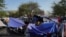 FILE - Migrants sent back to Mexico pass their time at an encampment yards away from the border in Reynosa, Mexico, April 1, 2022. 