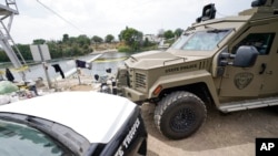 FILE - Texas Department of Safety vehicles are seen along the Rio Grande, on Sept. 21, 2021, in Del Rio, Texas. Former Trump administration officials are pressing Republican border governors to declare an "invasion" along the U.S.-Mexico border.