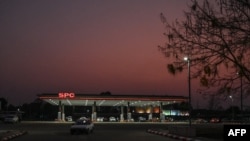 This photo taken on March 26, 2022, shows a car driving out of a Singapore Petroleum Company (SPC) petrol station in Naypyidaw, Myanmar.