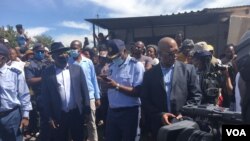 South Africa's Home Affairs Minister, Bheki Cele, police and other state security agents at the scene where Elvis Nyathi was killed.