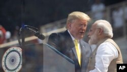 U.S. President Donald Trump and Indian Prime Minister Narendra Modi shake hands during a "Namaste Trump," event at Sardar Patel Gujarat Stadium, Monday, Feb. 24, 2020, in Ahmedabad, India.