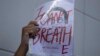 An activist holds up a picture of Thai dissident Wanchalearm Satsaksit during a rally in front of Cambodian Embassy in Bangkok, Thailand, Monday, June 8, 2020. (AP Photo/Sakchai Lalit) 