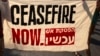 Natpis kojim se traži prekid vatre na protestu ispred izraelskog Kneseta (Menahem Kahana / AFP)
