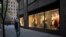 A man wearing a mask walks by a window display at a J Crew store in Rockefeller Center, May 2, 2020, in New York.